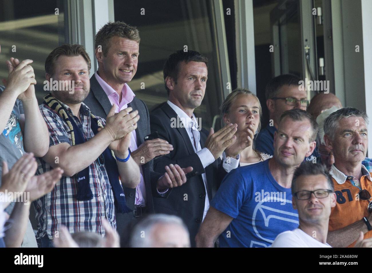 Incoming manager of Scottish Premiership club Celtic Ronny Deila (C) and Director of Football in Stromsgodset, Jostein Flo (2nd) from left) on the stand during the match between Deila`s former club Stromsgodset and Haugesund in the Norwegian top football league in Drammen, 9 June 2014. Photo by Audun Braastad, NTB scanpix Stock Photo